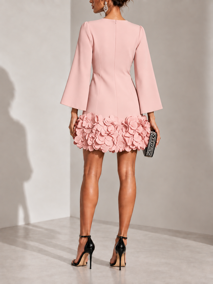 Back view of the pink dress, showing the centre zip and the 3D petal trim around the hem. 10