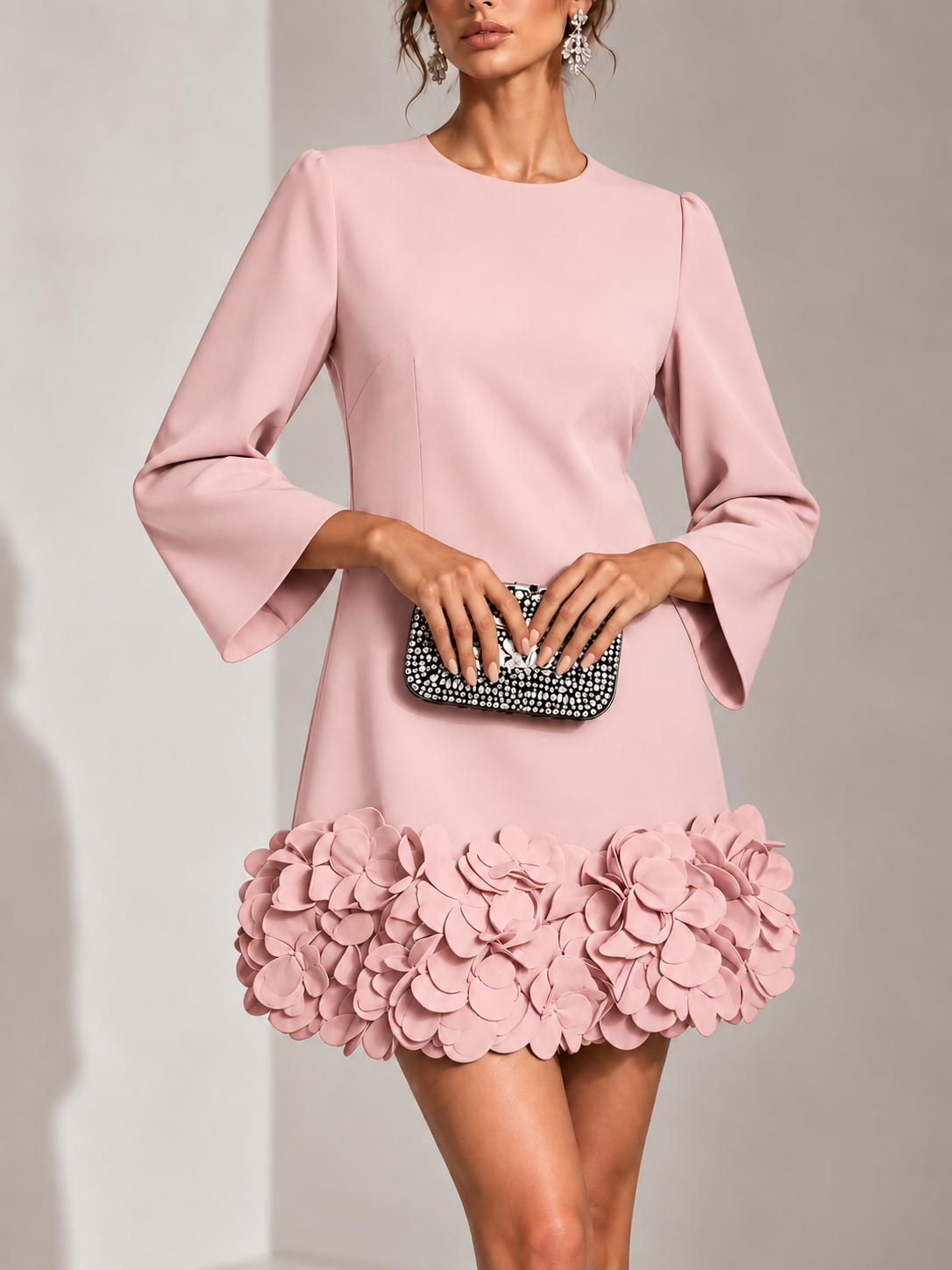 Pink version of the dress, close front view, with round neckline, flared sleeves and a hem of layered petals. 9