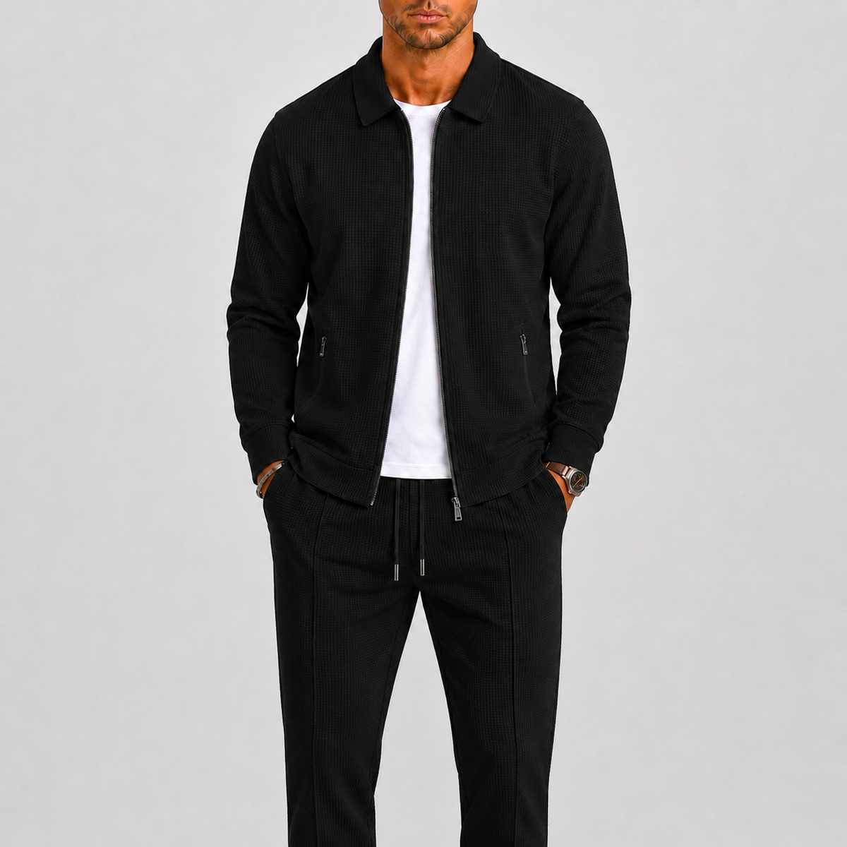 Model wears the textured collared zip jacket and pintucked drawstring trousers in black, with a white t-shirt 3