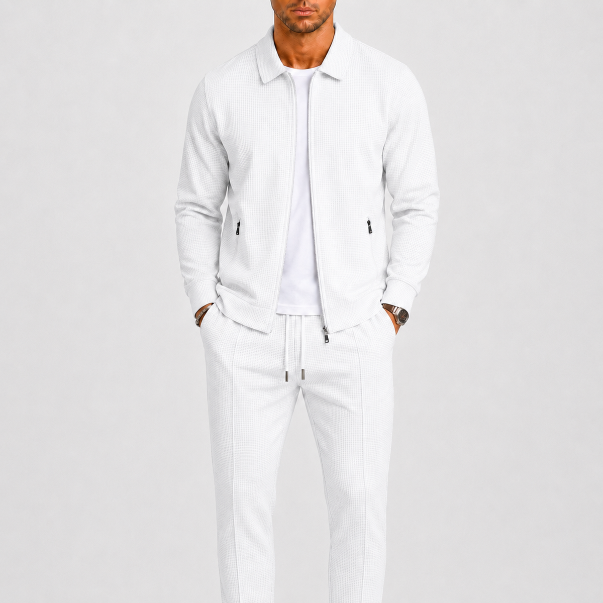 Model wears the same waffle-textured two piece set in white, with zip jacket and trousers 2