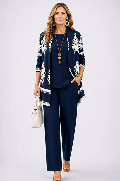 Model in navy set with a cardigan in white ornate motifs and border trim 7