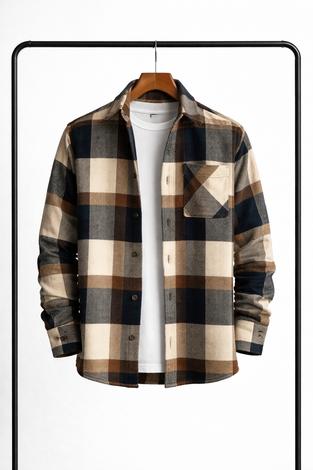 Front view of the overshirt in cream, brown, navy and grey check, hanging open over a white tee. 5