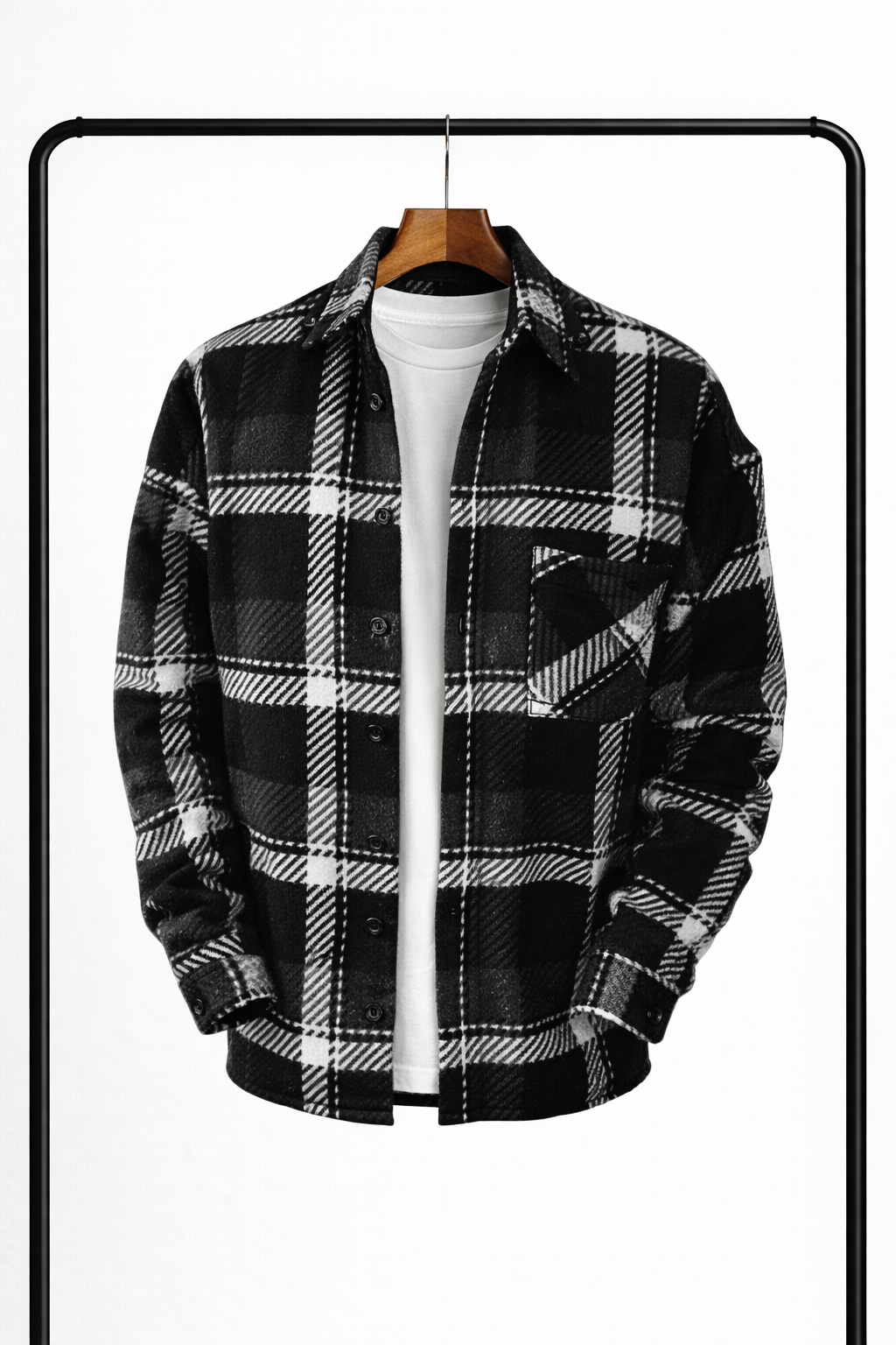 Front view of the overshirt in black, grey and white check, hanging open over a white tee, with chest pocket. 3
