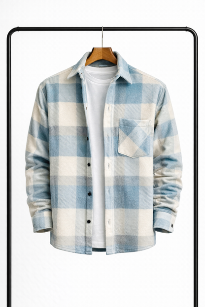 Front view of the overshirt in pale blue and cream check, hanging open over a white tee, with chest pocket. 1