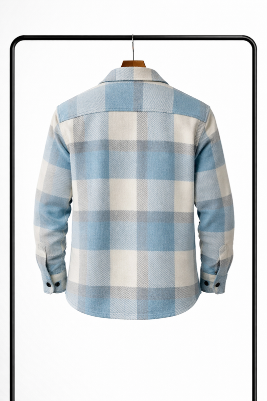 Back view of the pale blue, cream and grey checked overshirt on a hanger, showing the yoke and buttoned cuffs. 2