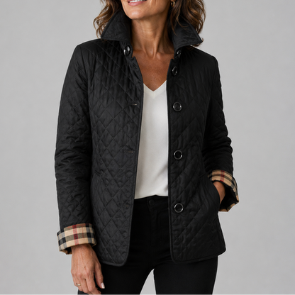 Black quilted jacket with rolled-up checked cuffs, worn over a white top and black trousers 3