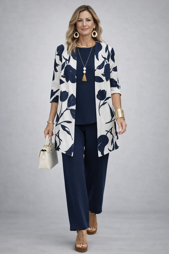Model in navy top and trousers with a cream cardigan printed with large navy tulips 8
