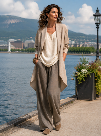 Model wearing the full three-piece set outdoors on a lakeside promenade, with water, hills and a lamppost behind. 7