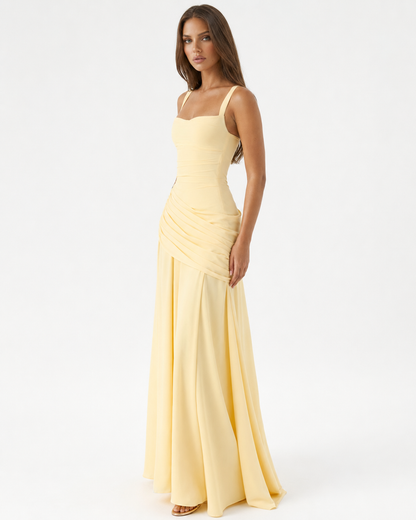 Pale yellow version worn by a model at a three-quarter angle, showing the ruched bodice and long flowing skirt. 2