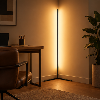 Black corner floor lamp lit warm beside a wooden desk and leather chair in a home office, with a large plant. 3