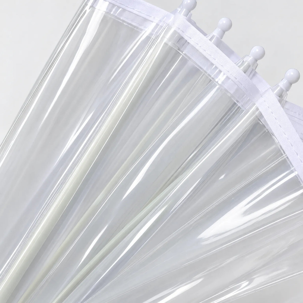 Close-up of the transparent canopy panels, white fabric edging and rounded white rib tips. 4