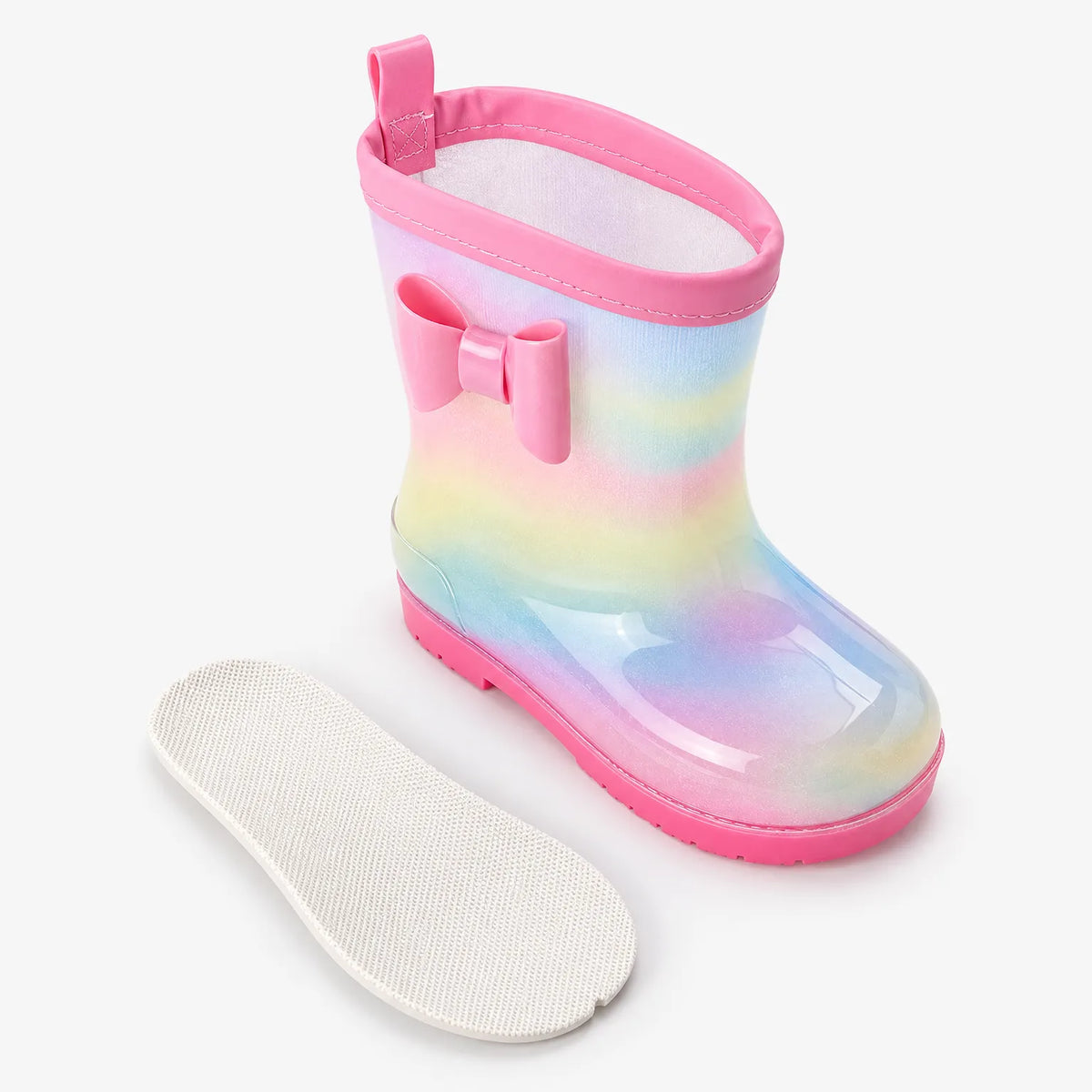 Single rainbow welly with pink bow and pull tab, shown with its removable white textured insole laid beside it. 4