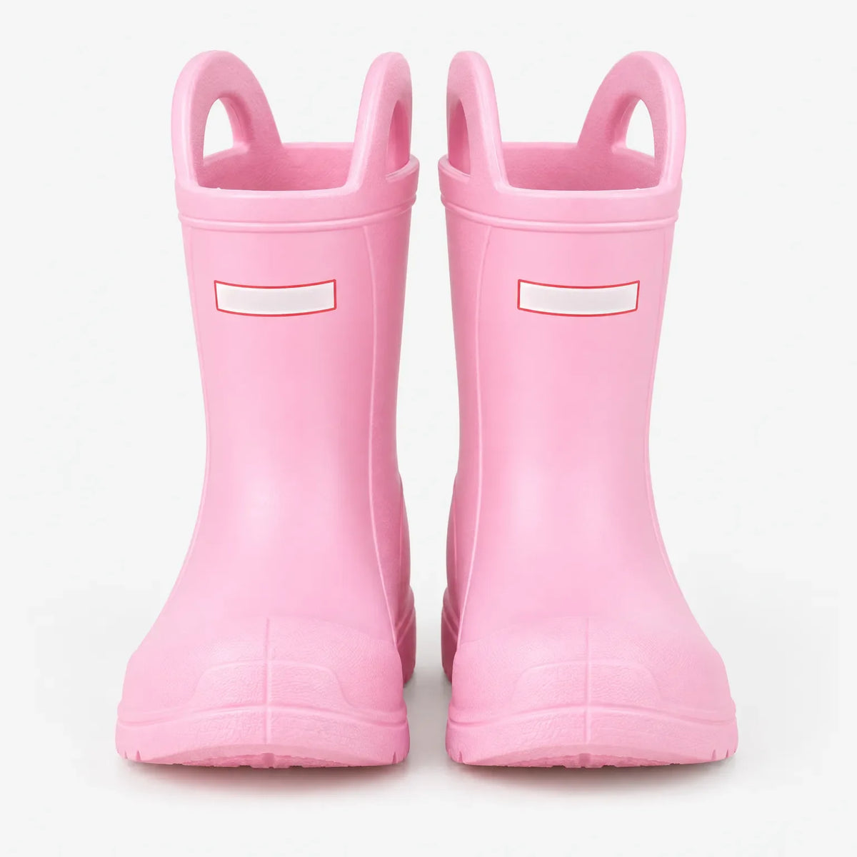 Front view of a pair of pink wellies with two pull-on handles and a blank white tab on each boot. 2