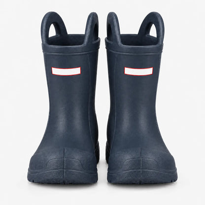 Front view of a pair of navy blue wellies showing the two top handles, blank white tabs and chunky toe caps. 4