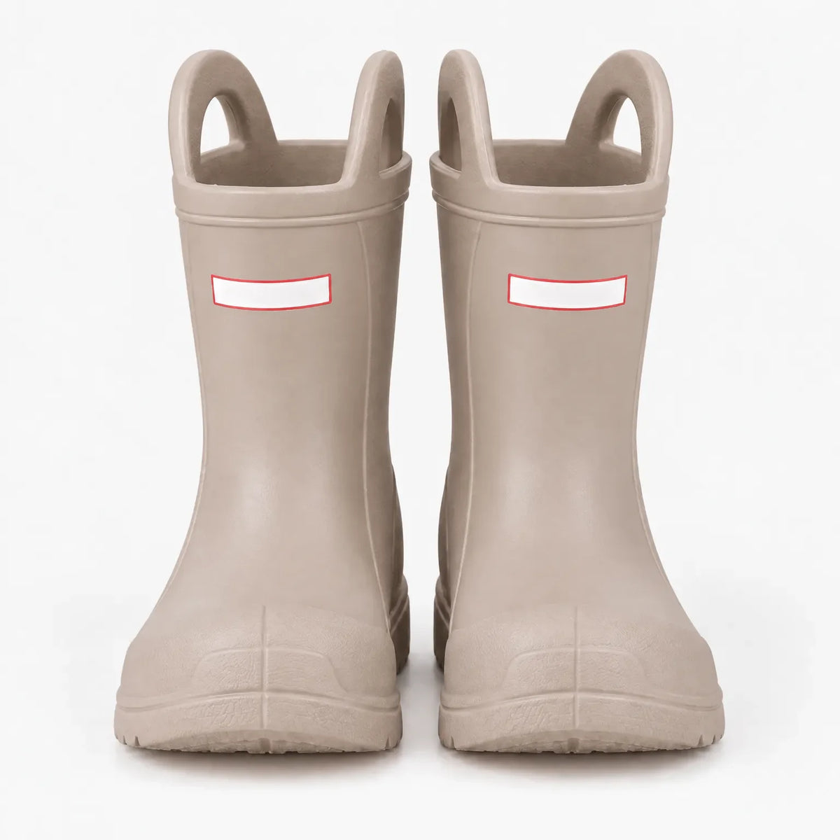 Front view of a pair of beige wellies with two pull-on handles and blank white tabs on a plain background. 7