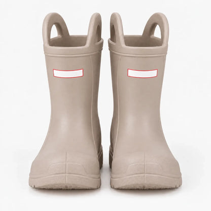 Front view of a pair of beige wellies with two pull-on handles and blank white tabs on a plain background. 7