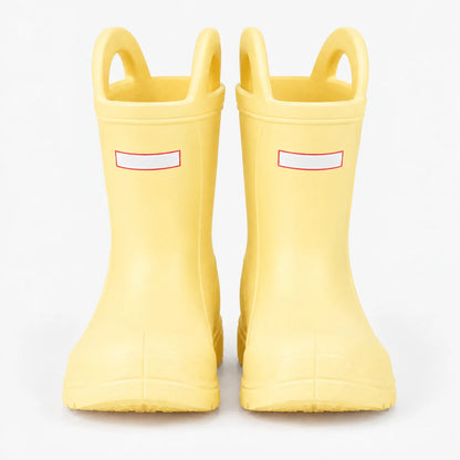 Front view of a pair of pale yellow wellies with two pull-on handles and blank white tabs on a plain background. 9