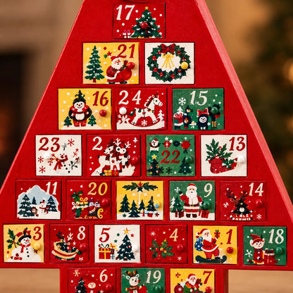 Close-up of the painted numbered drawers, each with a small round knob and a festive scene such as Santa, a snowman or a rocking horse. 3