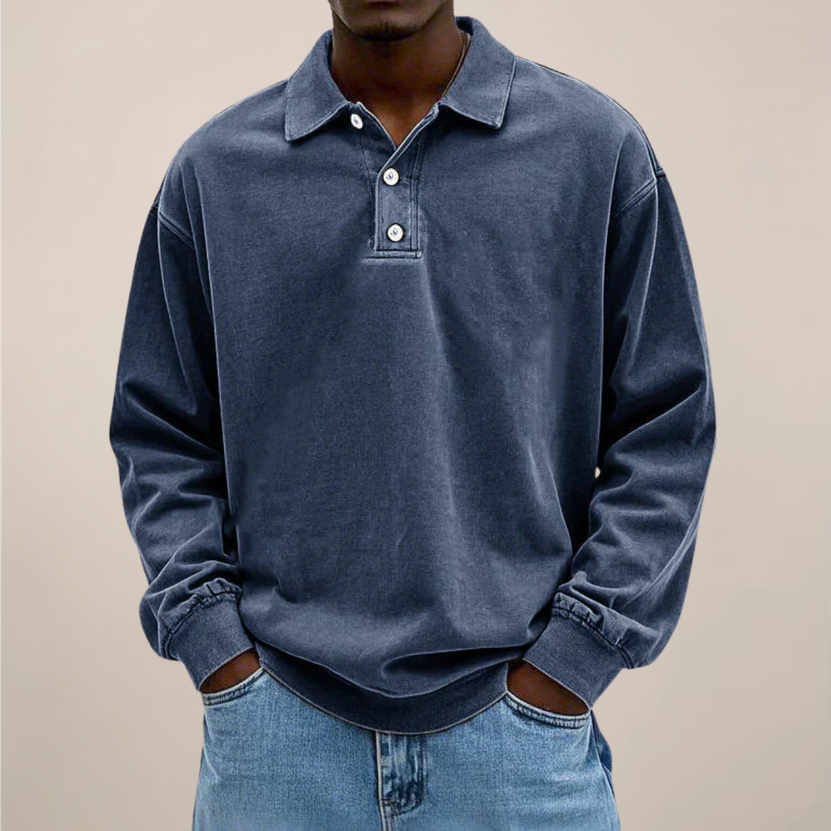 Model wearing the relaxed-fit long sleeve polo in washed dark navy blue, hands in the pockets of light blue jeans. 5