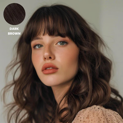 Woman with wavy dark brown hair and a full fringe, with a colour swatch 6