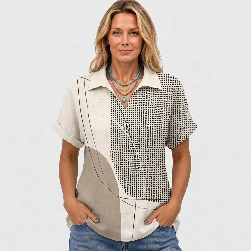Front view on a smiling model wearing a turquoise pendant necklace, hands in jeans pockets, sleeves cuffed 2