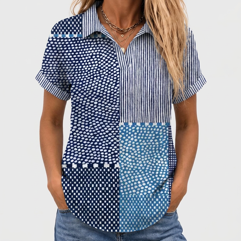 Close-up front view of the short-sleeved patchwork shirt worn with jeans and layered gold necklaces 1