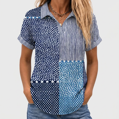 Close-up front view of the short-sleeved patchwork shirt worn with jeans and layered gold necklaces 1