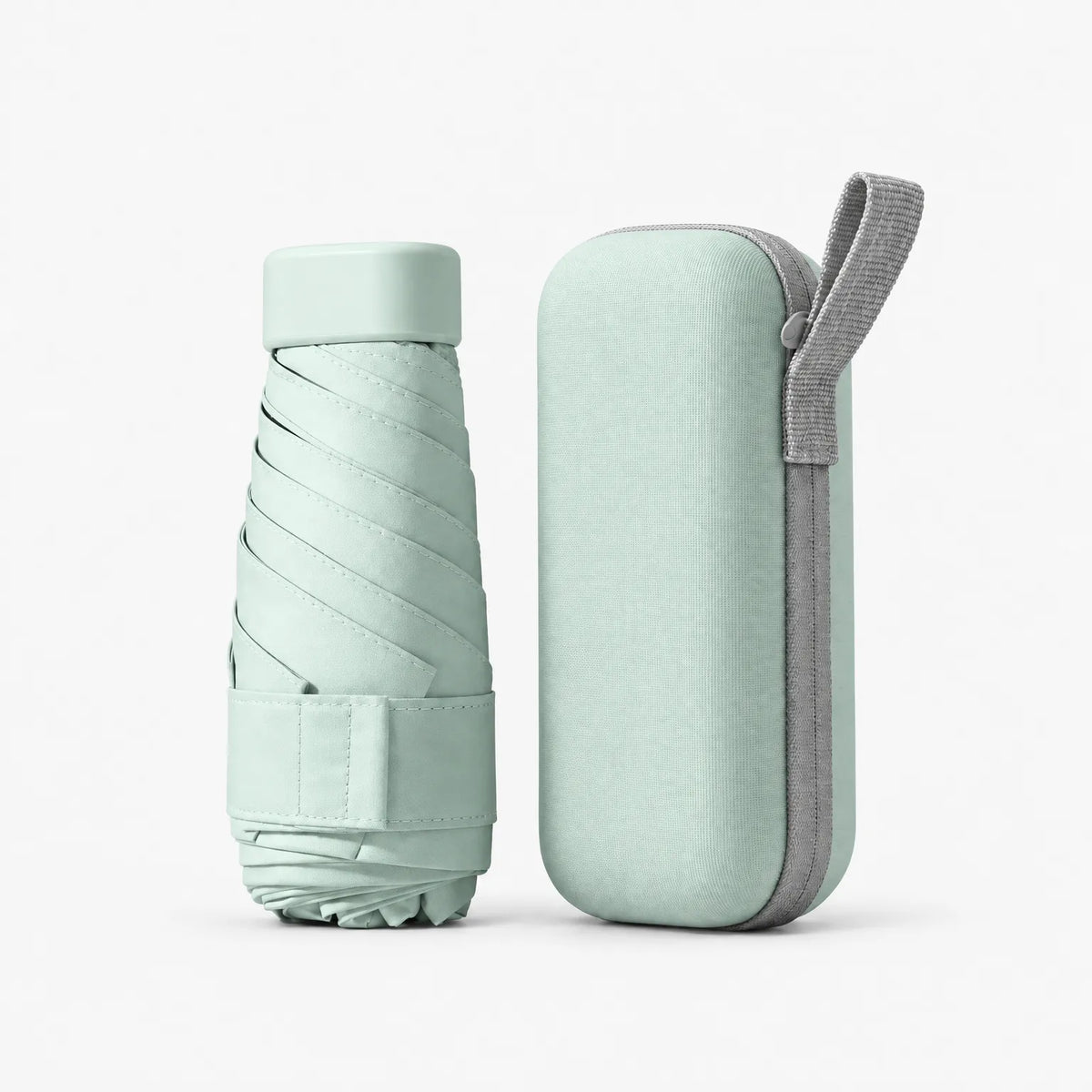 Folded pale green umbrella with a Velcro strap beside its matching hard case with a grey zip and carry loop. 8