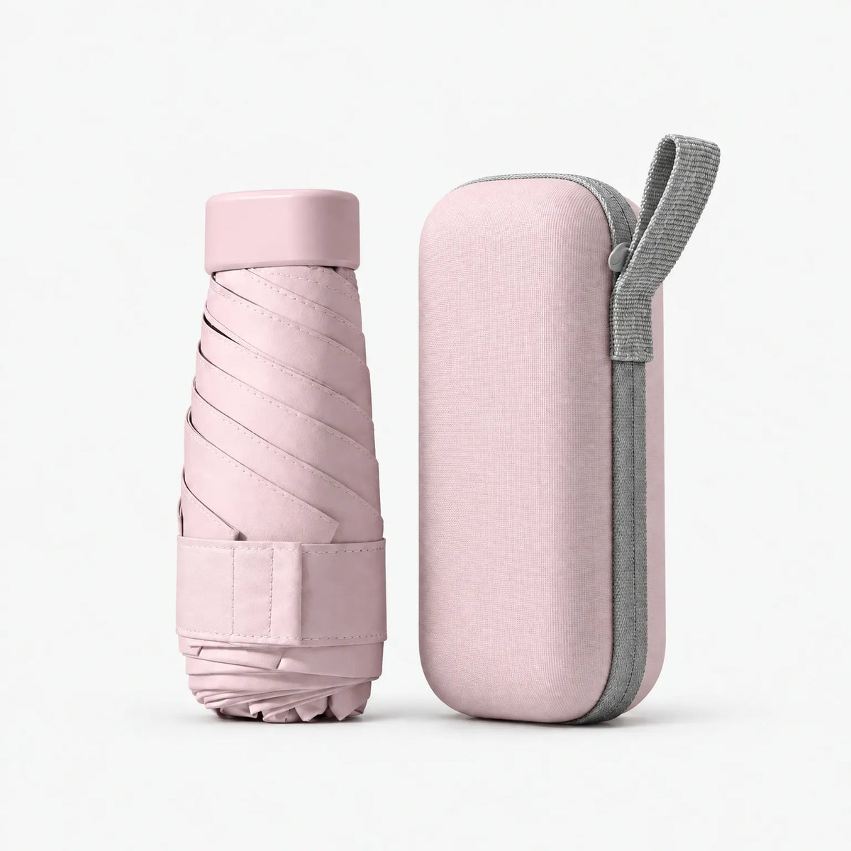 Folded pale pink umbrella with a Velcro strap beside its matching pink hard case with a grey zip and carry loop. 9
