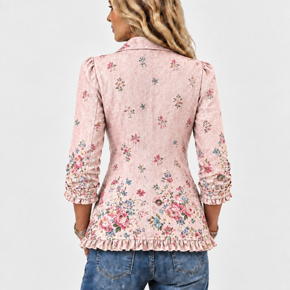 Back view of the pink jacket showing scattered floral print, denser flowers near the hem, ruffled cuffs and hem. 5