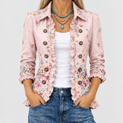 Close-up of the pink floral jacket worn open over a white top, showing ruffled edges, brown buttons and cuffs. 1
