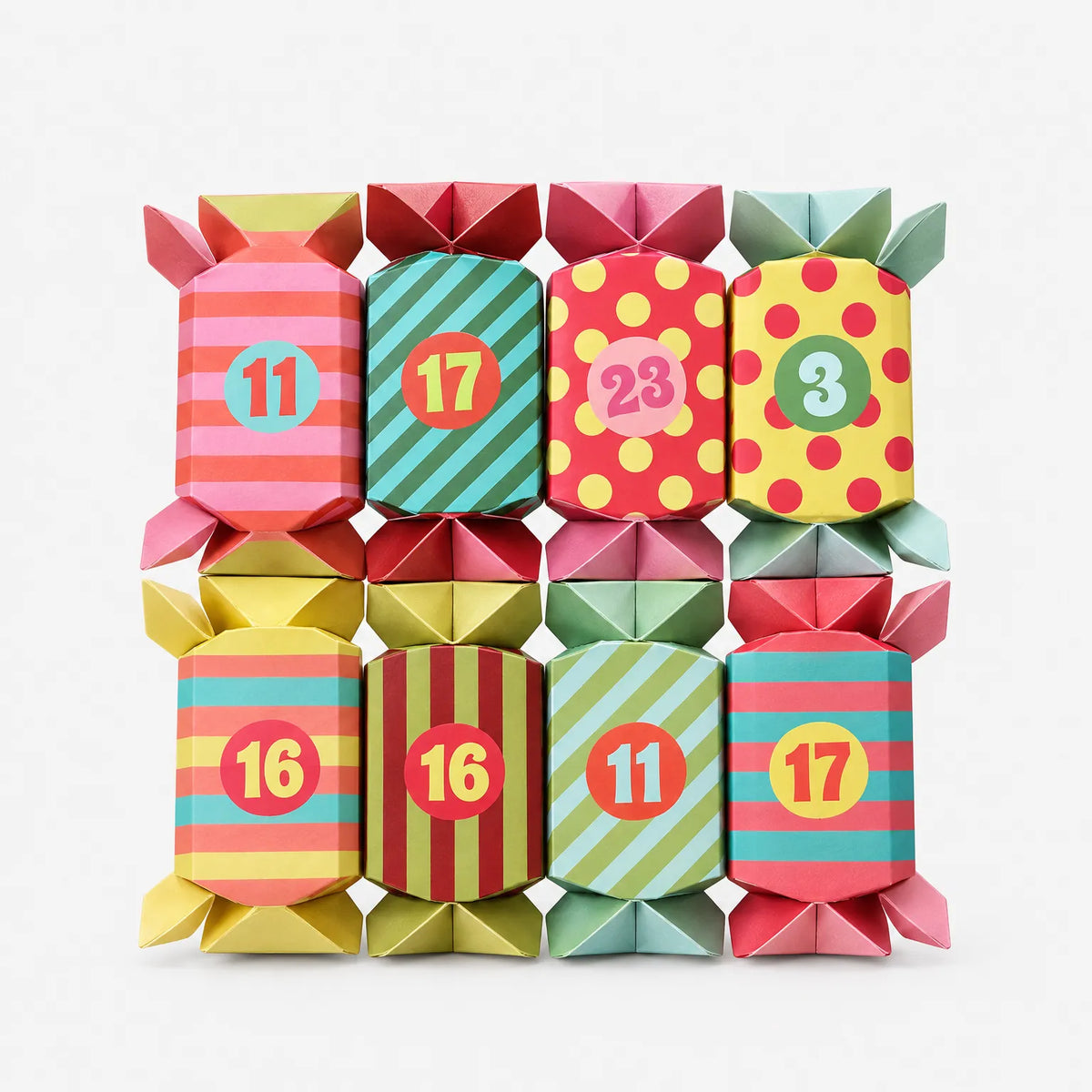Eight bright cracker-style paper boxes with striped and polka-dot designs and round number stickers, laid out in two rows on a plain white background. 2