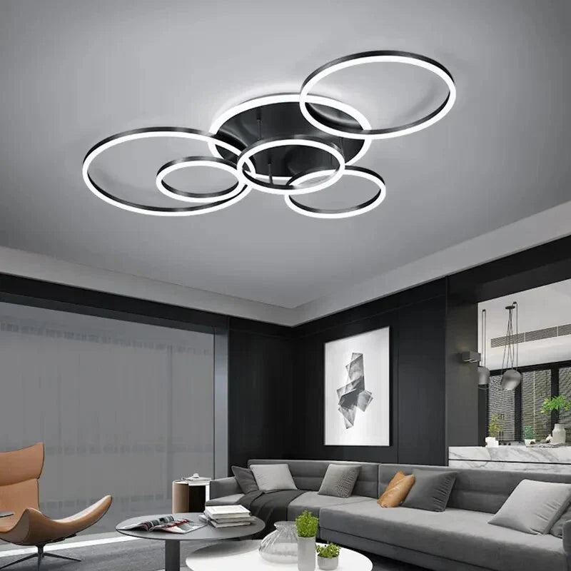 Black-framed ring light with cooler white glow above a grey sofa in a modern living room 8