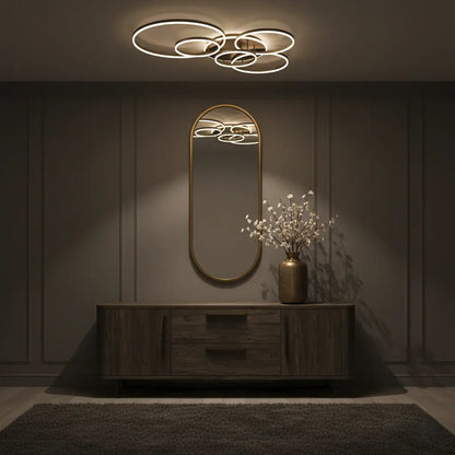 Ring light reflected in an oval mirror above a wooden sideboard in a dimly lit hallway 7