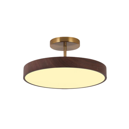 Dark wood-effect round semi-flush light with a brass-coloured stem and canopy, lit and shown against a plain white background. 2