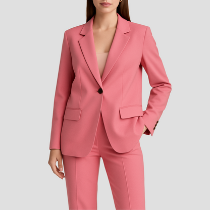 Model wearing the pink suit, close crop showing the single dark button and flap pockets 3