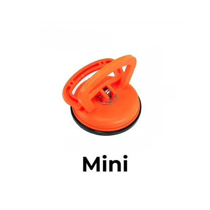 Orange plastic suction puller in the smaller size, with a folding handle and black rubber rim, on a white background. 6