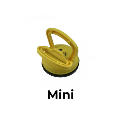 Yellow plastic suction puller in the smaller size, with a folding handle and black rubber rim, on a white background. 1