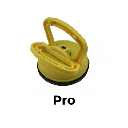 Yellow plastic suction puller in the larger size, with a folding handle and black rubber rim, on a white background. 4