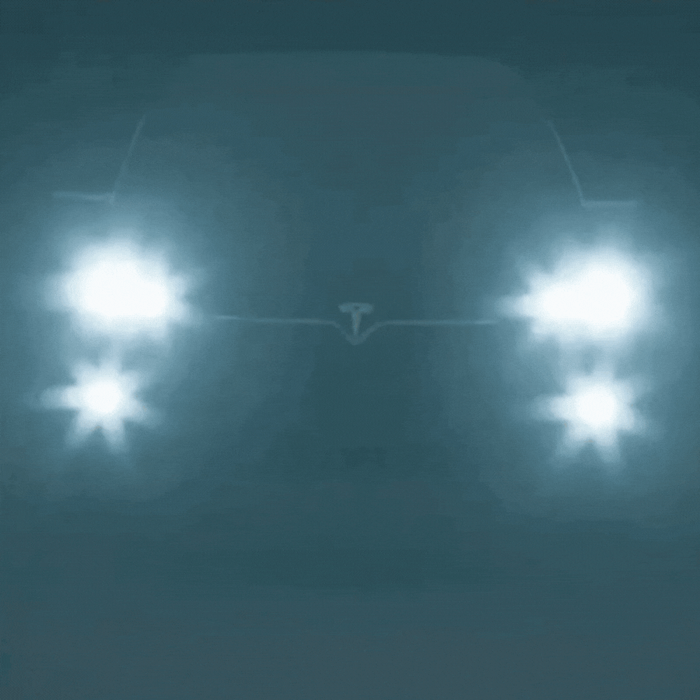 Blurry car headlights glowing in thick night fog, with a bluish tint and starburst glare around each lamp. 6
