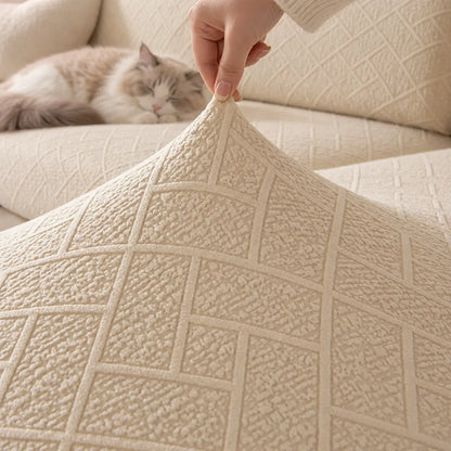 Hand lifting the corner of a cream cover to show its stretch and textured pattern 12