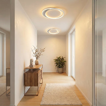 Two matching ring lights glowing along a narrow hallway with a wooden console and rug 5