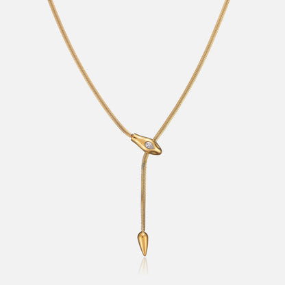 Gold-tone lariat necklace with flat snake chain, snake-head slider set with a clear teardrop stone, front view 1