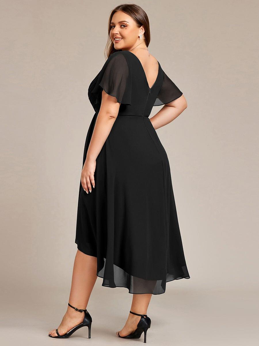 Plus-size model seen from behind in the black dress, showing the V back, zip and sheer flutter sleeves. 27