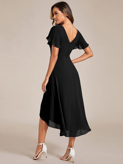 Back view of the black high-low dress showing the deep V back, zip and flowing uneven chiffon hem. 22