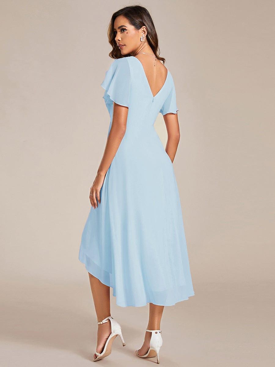 Back view of the light blue chiffon dress, showing the deep V back, zip and asymmetric high-low hemline. 85