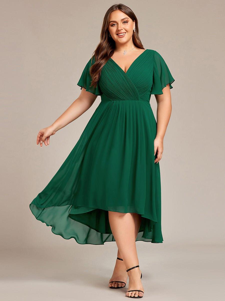Plus-size model in the dress in dark green, front view with the skirt swinging out and black heels. 36
