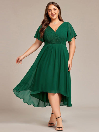 Plus-size model in the dress in dark green, front view with the skirt swinging out and black heels. 36