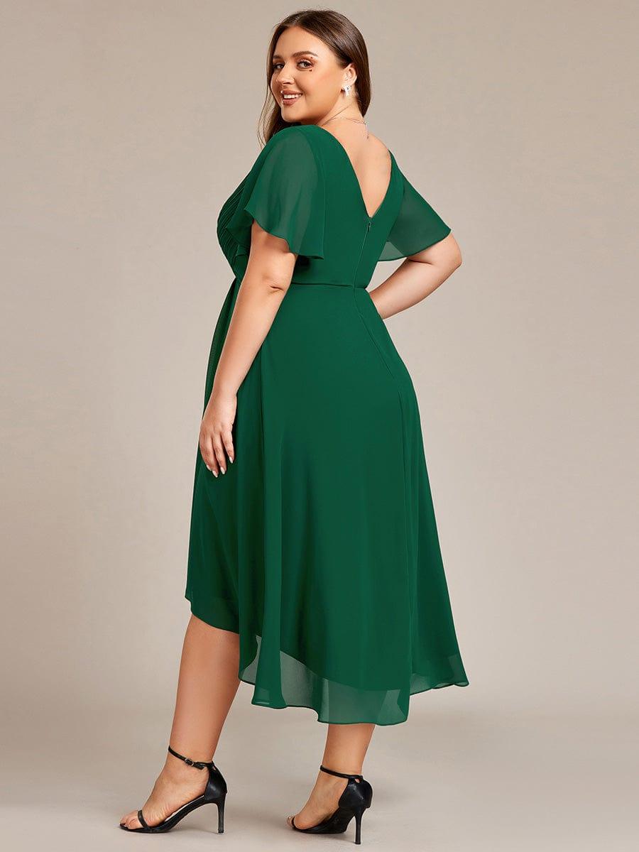 Back view of the dark green dress on a plus-size model, showing the V back, zip and sheer flutter sleeves. 37