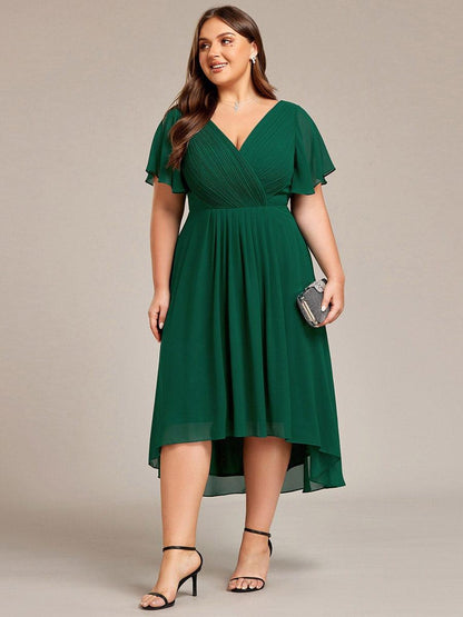 Plus-size model in the dark green dress holding a sparkly clutch, front view with black heels. 40